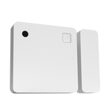 White electronic device with a small black circle and square button on a white background